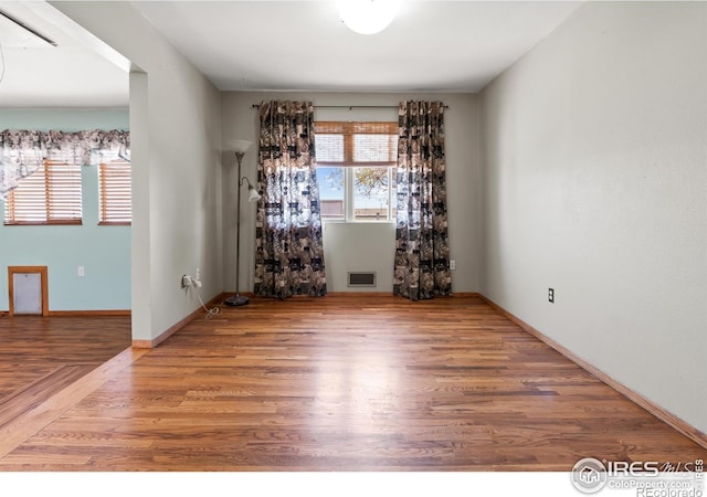 spare room with hardwood / wood-style flooring