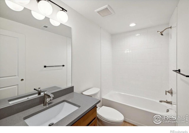 full bathroom with vanity, toilet, and tiled shower / bath