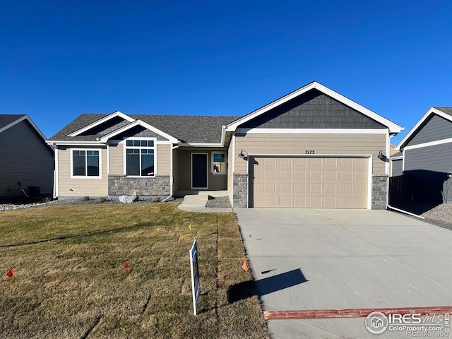 7173 Rye Grass Dr, Wellington, CO 80549 - view of front of home with a front yard, driveway, stone siding, and a garage