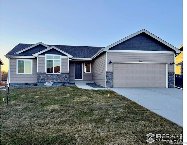 view of front of house with a front yard and a garage