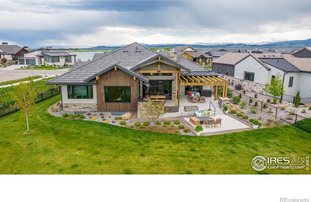 rear view of property with a yard and a patio