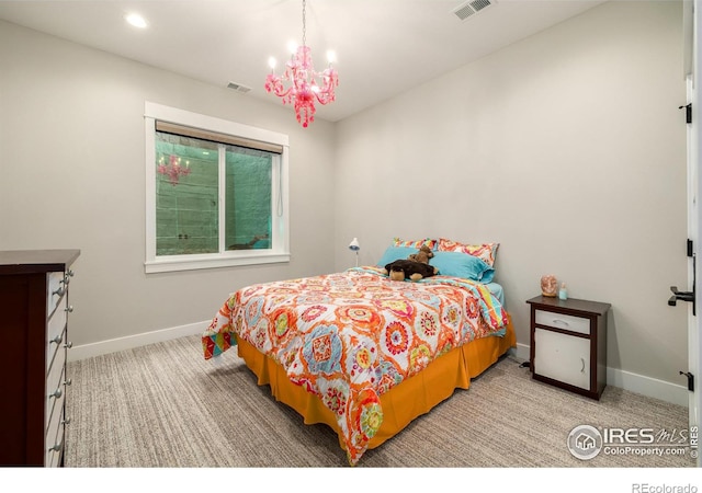 bedroom with an inviting chandelier and carpet