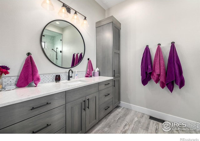 bathroom with hardwood / wood-style flooring and vanity