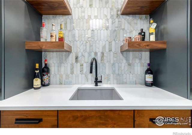 kitchen with sink and tasteful backsplash