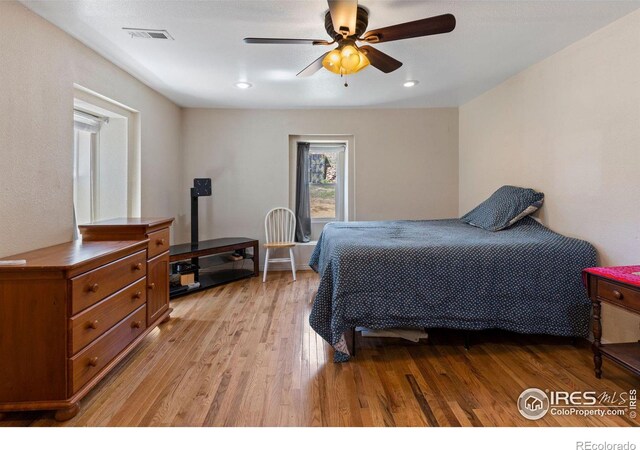 bedroom with ceiling fan and light wood-type flooring