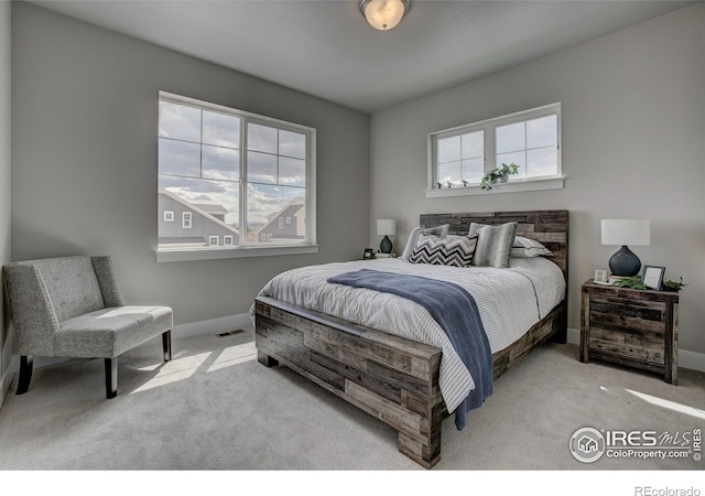 bedroom featuring light carpet