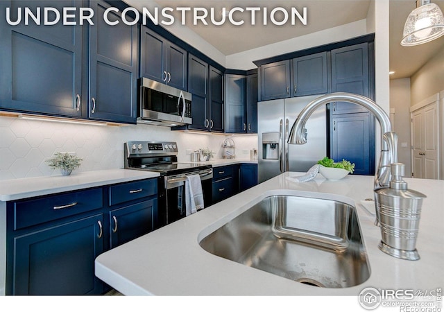 kitchen with sink, decorative backsplash, hanging light fixtures, and stainless steel appliances