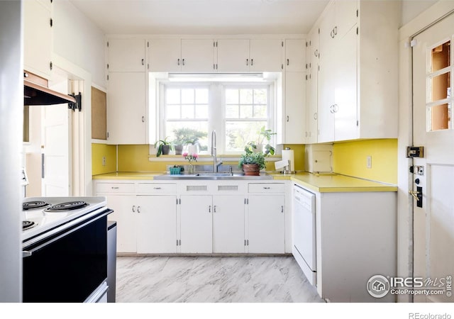 kitchen with sink, white appliances, range hood, and white cabinets