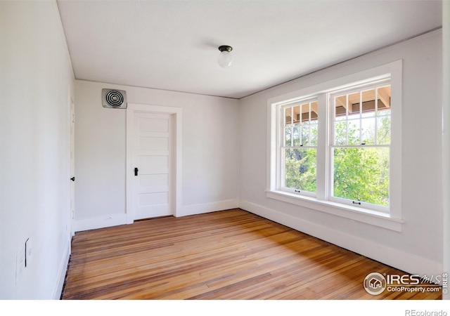 unfurnished room with light hardwood / wood-style floors