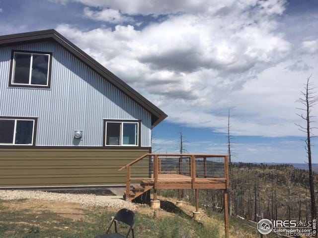 view of side of home with a deck