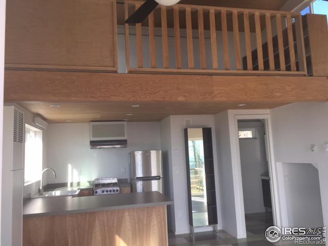 kitchen with sink, stainless steel fridge, and stove