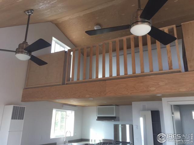 room details featuring refrigerator, sink, ceiling fan, and range hood