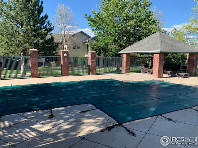 view of swimming pool featuring a patio and a gazebo