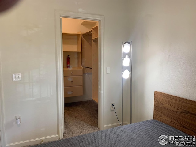 unfurnished bedroom featuring carpet and a spacious closet