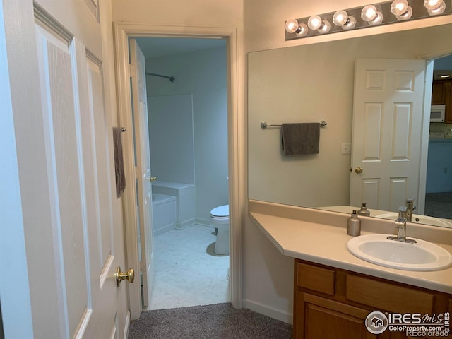 bathroom with toilet, tub / shower combination, and vanity