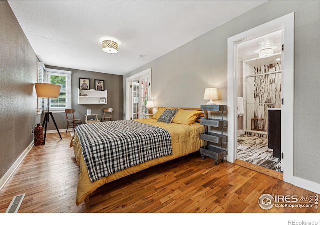 bedroom with hardwood / wood-style floors