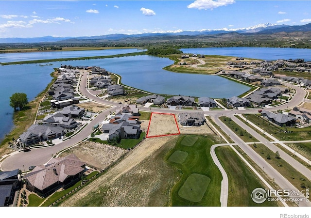 birds eye view of property with a water and mountain view