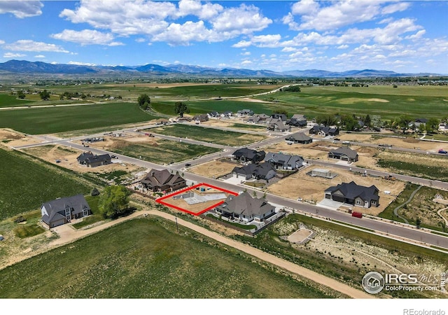 birds eye view of property with a mountain view