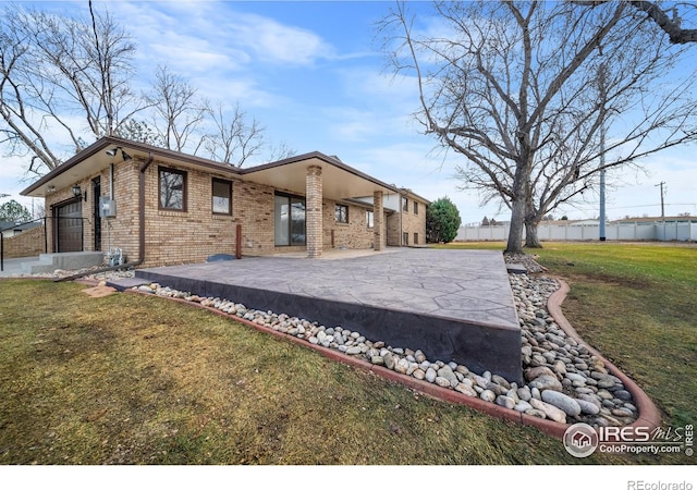 exterior space with a patio and a lawn