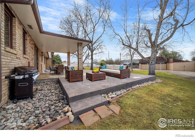 view of patio / terrace with area for grilling, an outdoor structure, and outdoor lounge area