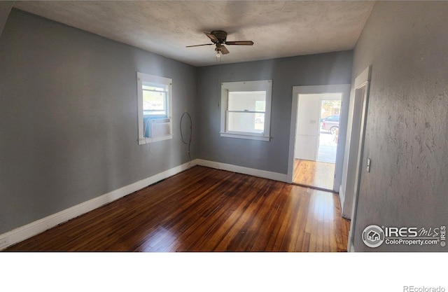 unfurnished room featuring ceiling fan and dark wood-type flooring