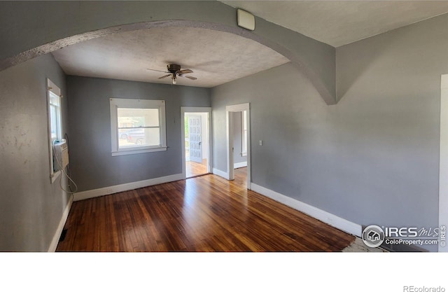 spare room featuring wood-type flooring and ceiling fan