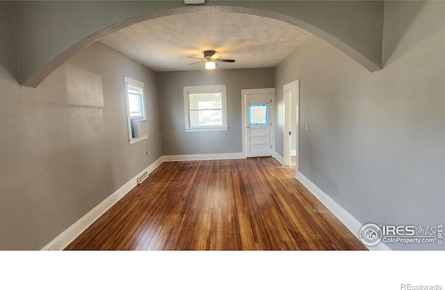 entryway with a textured ceiling, ceiling fan, and hardwood / wood-style flooring