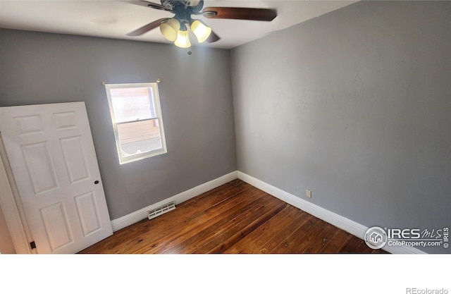 empty room with ceiling fan and hardwood / wood-style floors