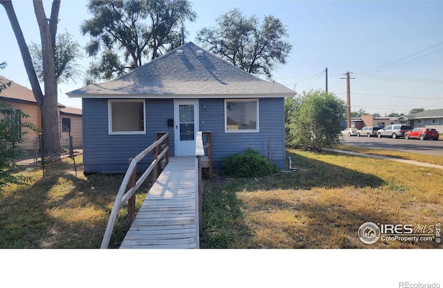 bungalow-style house featuring a front yard