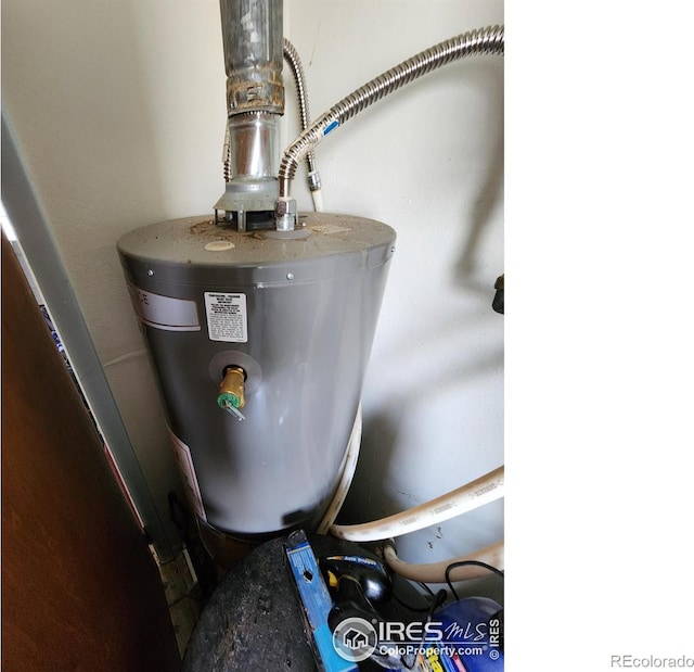 utility room featuring water heater