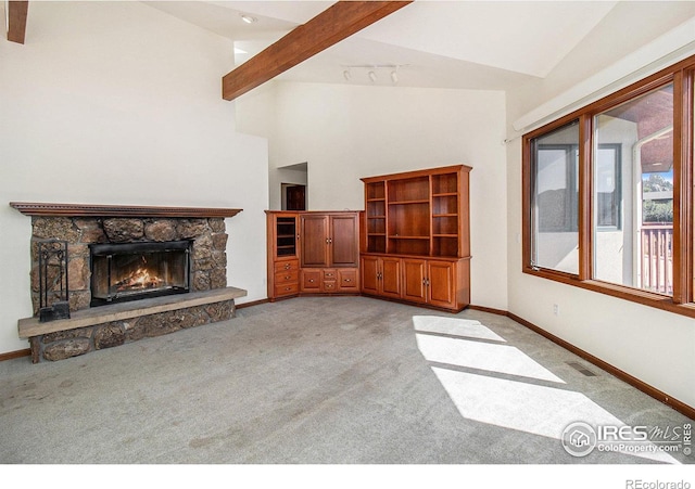 unfurnished living room featuring beamed ceiling, light colored carpet, a fireplace, and high vaulted ceiling