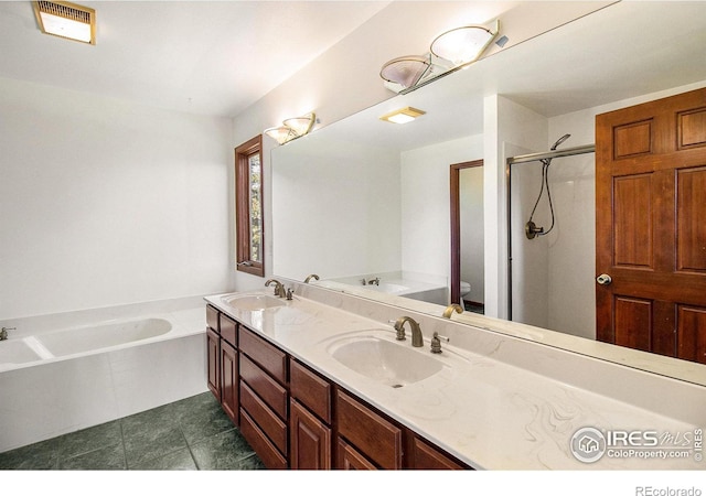 full bathroom with tile patterned floors, vanity, toilet, and independent shower and bath