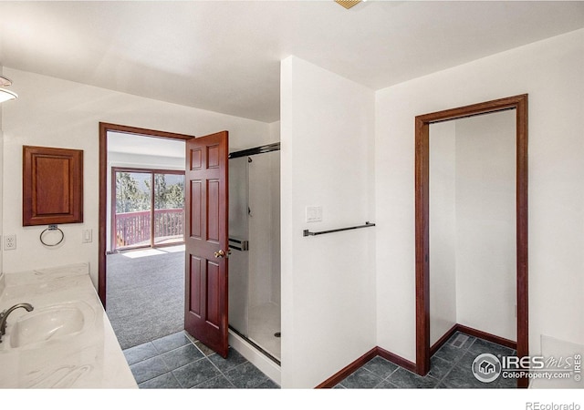 bathroom with vanity and a shower with door