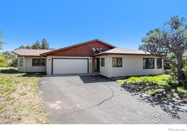 ranch-style home featuring a garage