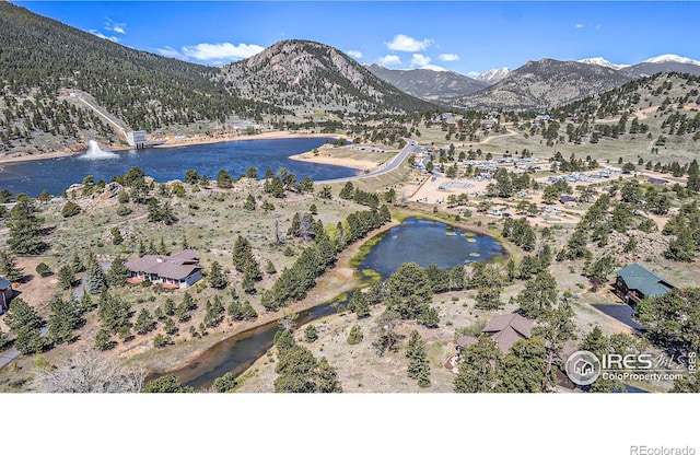 bird's eye view with a water and mountain view