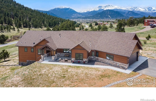 view of front of property with a patio and a mountain view