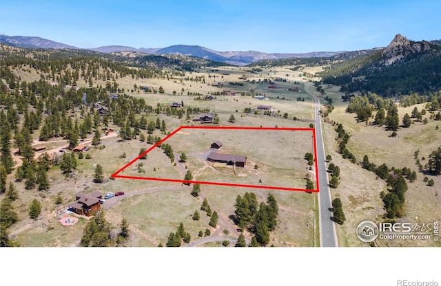 birds eye view of property with a mountain view