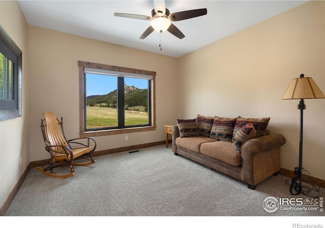 carpeted living room with ceiling fan and plenty of natural light