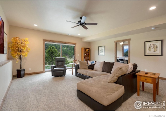 carpeted living room featuring ceiling fan