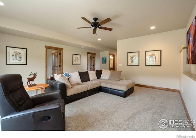 carpeted living room with ceiling fan