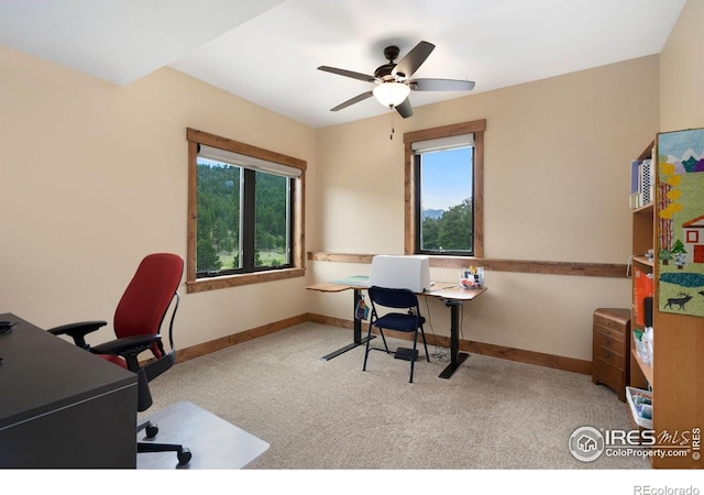 carpeted office space with ceiling fan