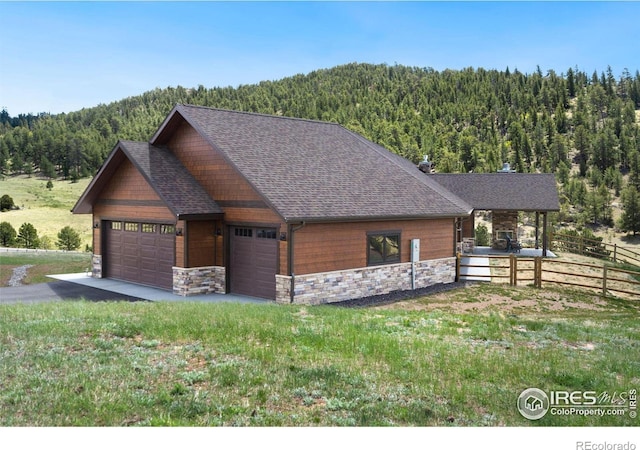 view of front of house featuring a garage and an outdoor structure