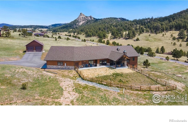 birds eye view of property featuring a mountain view and a rural view