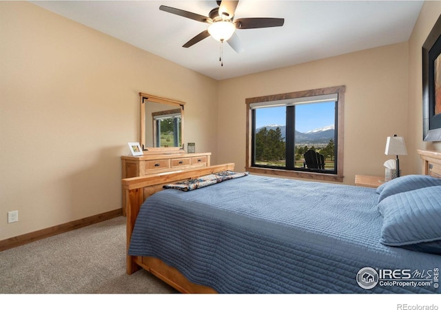 bedroom featuring ceiling fan and carpet