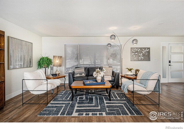 living room with dark wood-style floors and baseboards