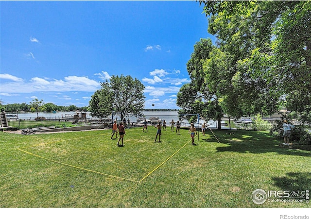 view of yard featuring a water view and fence