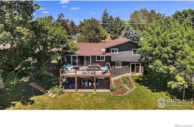 back of house featuring a deck, a yard, and a patio area