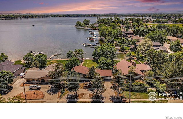 drone / aerial view with a residential view and a water view