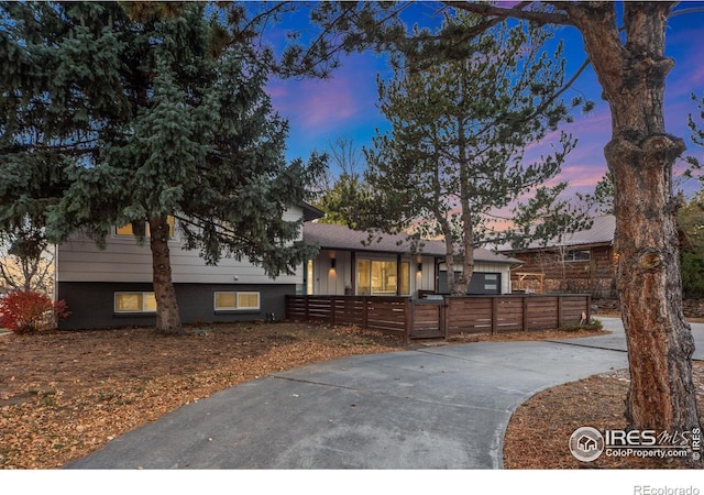 tri-level home featuring a fenced front yard