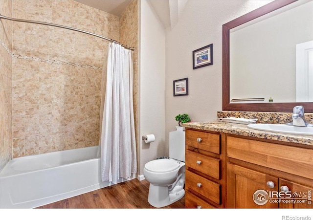 full bathroom with hardwood / wood-style floors, vanity, toilet, and shower / bath combo with shower curtain